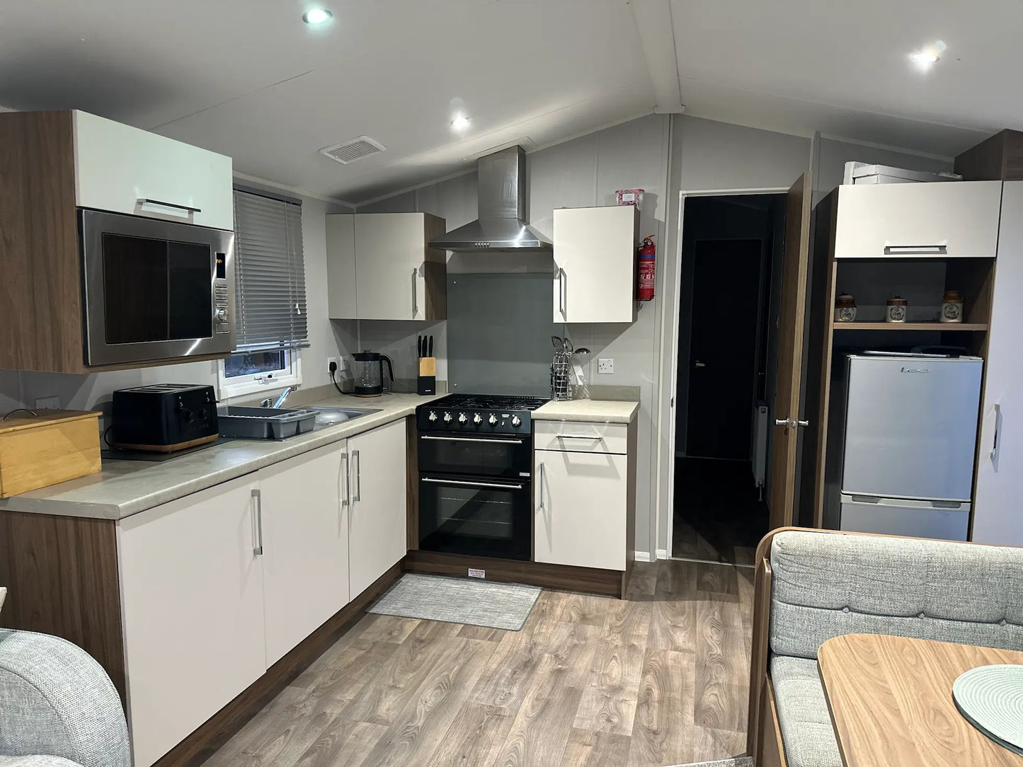 Butlins caravan kitchen with modern appliances, oven, and fridge-freezer – perfect for self-catering holidays
