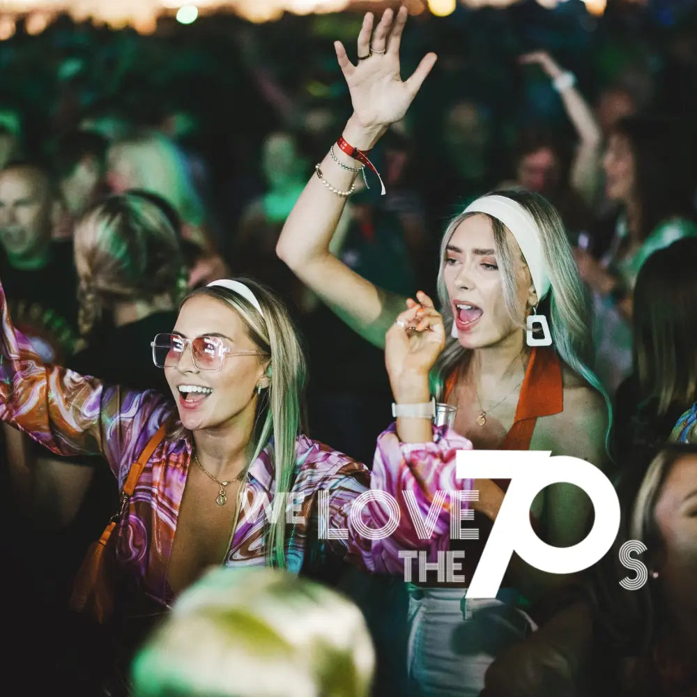 People enjoying a Butlins adult weekender concert with 'We Love The 70s' text overlay.