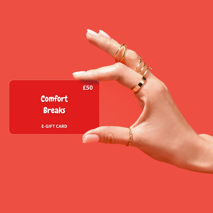 Hand holding a red 'Comfort Breaks' e-gift card against a red background